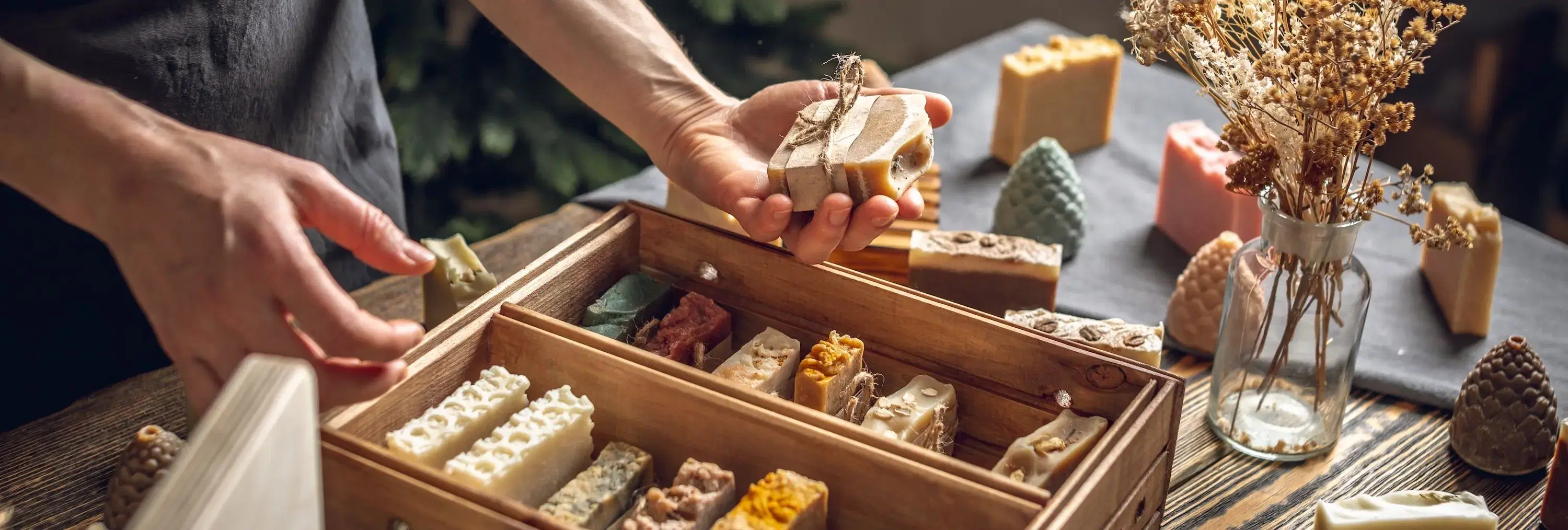 man holding handmade soaps